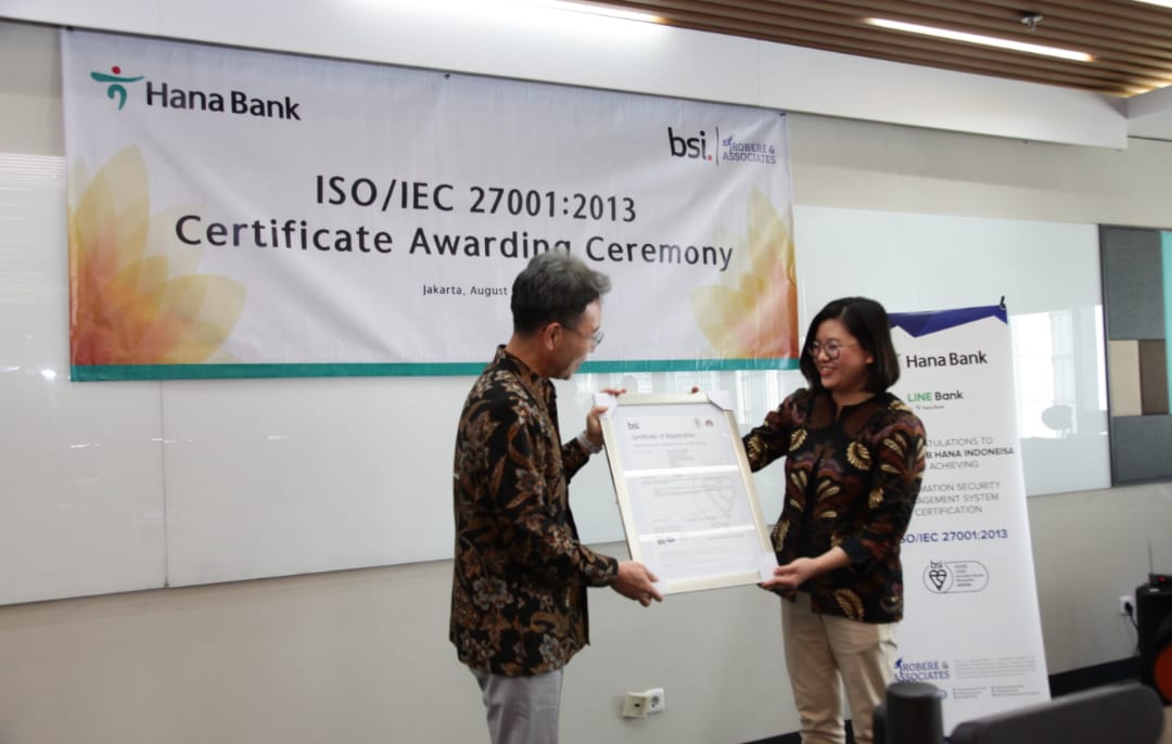 Bank Hana Raih Sertifikasi ISO/IEC 27001:2013, secara simbolis diterima oleh Direktur Utama Bank Hana Park Jong Jin dan diserahkan oleh Direktur Robere & Associates Indonesia Vera Anita sebagai partner dan perwakilan dari BSI, di Kantor Pusat Bank Hana, Jakarta, pada Rabu (9/8/2023). dok. ist. Tingkatkan Standar Keamanan Sistem Informasi Bank Hana Raih Sertifikasi ISO/IEC 27001:2013